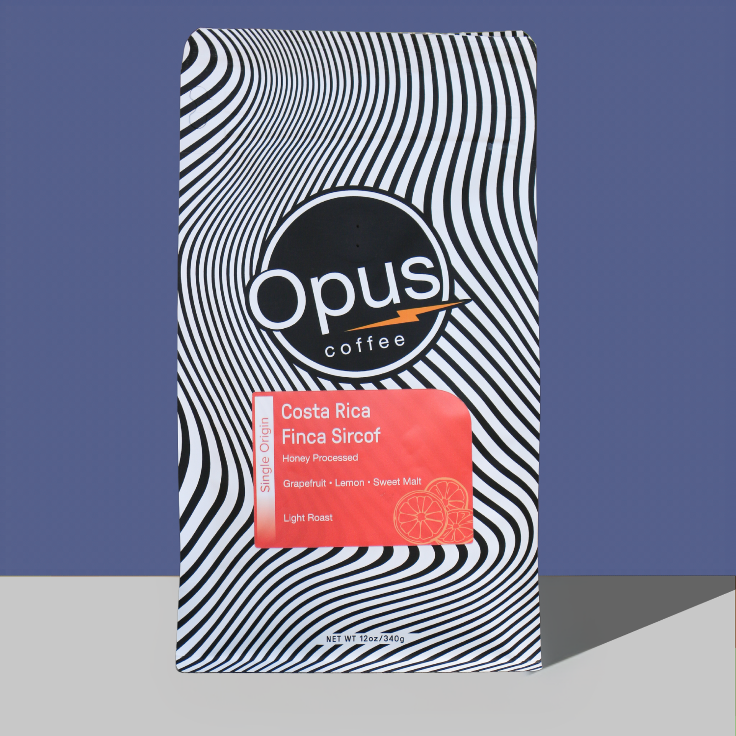 Bag of Costa Rica Finca Sircof coffee on plain blue background.