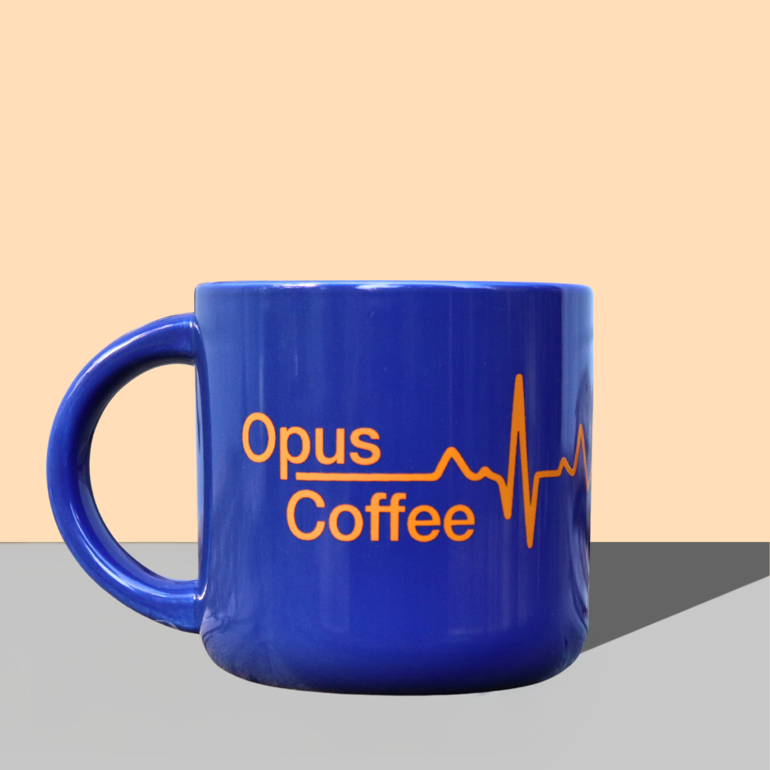 blue mug with opus coffee heartbeat logo.