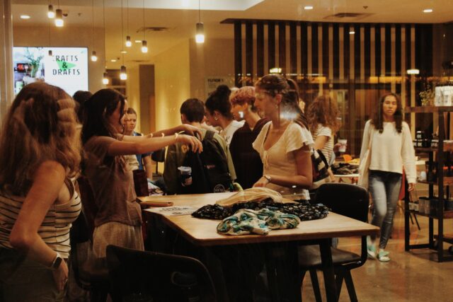 A group of people inside Opus Coffee Innovation during a thrift swap.