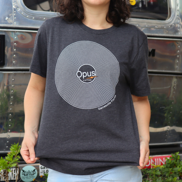 Girl wearing the Opus Coffee vinyl design shirt in front of the airstream.