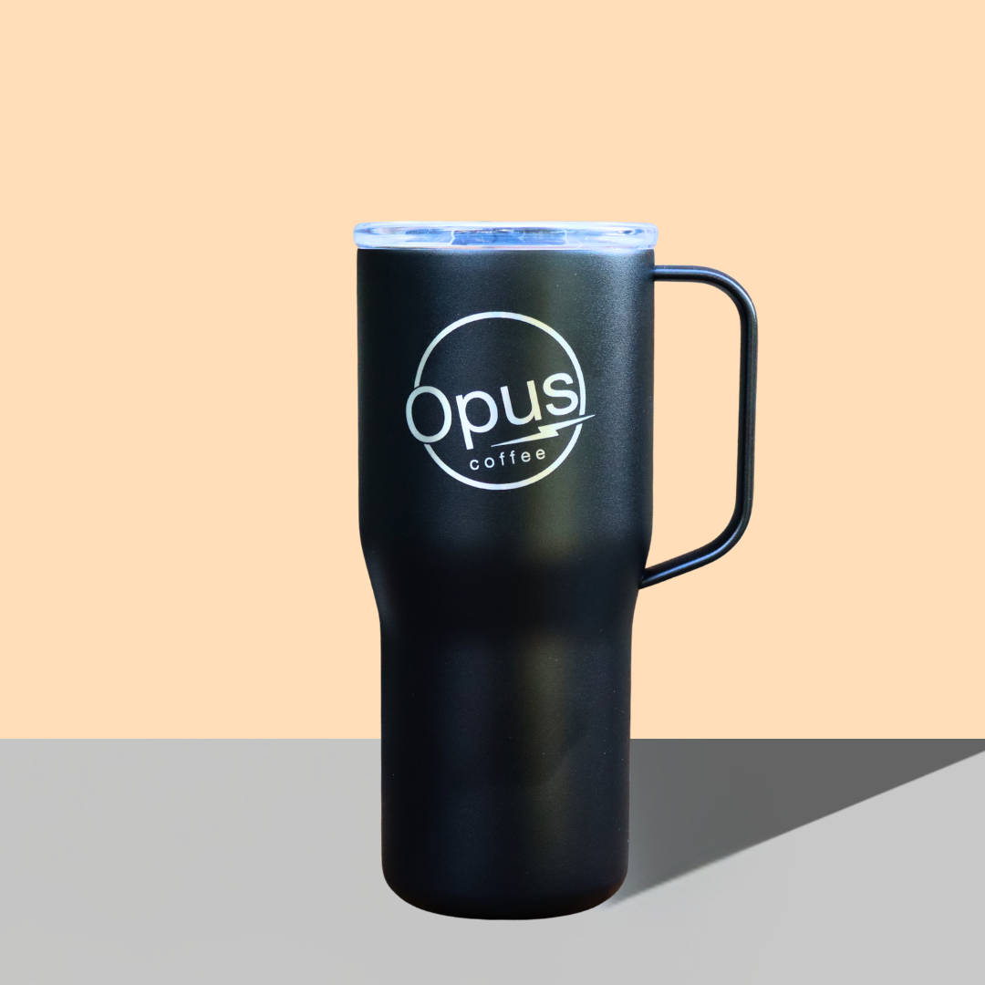 Black Opus Travel mug on orange background