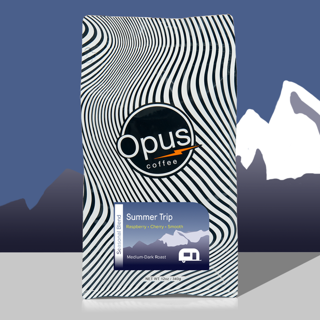 Opus Coffee Summer Trip Seasonal Blend wavy bag on a mountain backdrop bag.