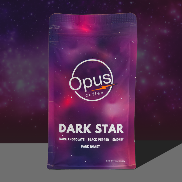 Opus coffee dark star blend coffee bag that is pink and purple with stars on a dark background.