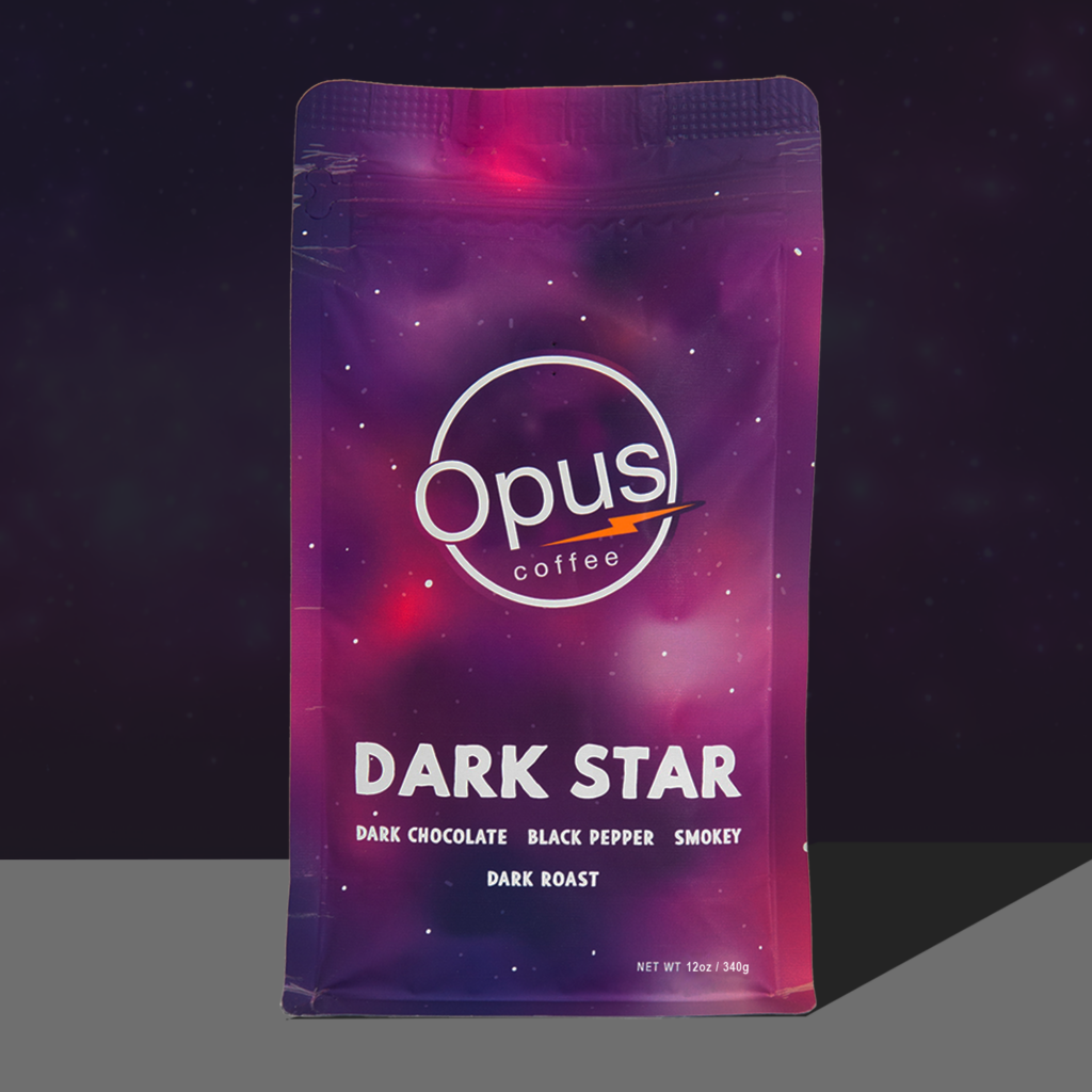 Opus coffee dark star blend coffee bag that is pink and purple with stars on a dark background.