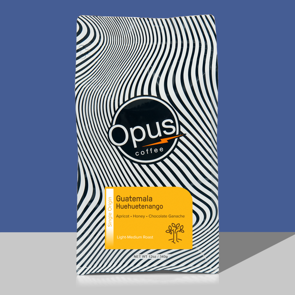Opus retail bag of Guatemala Huehuetenango coffee. Black and white wavy bag with yellow label.