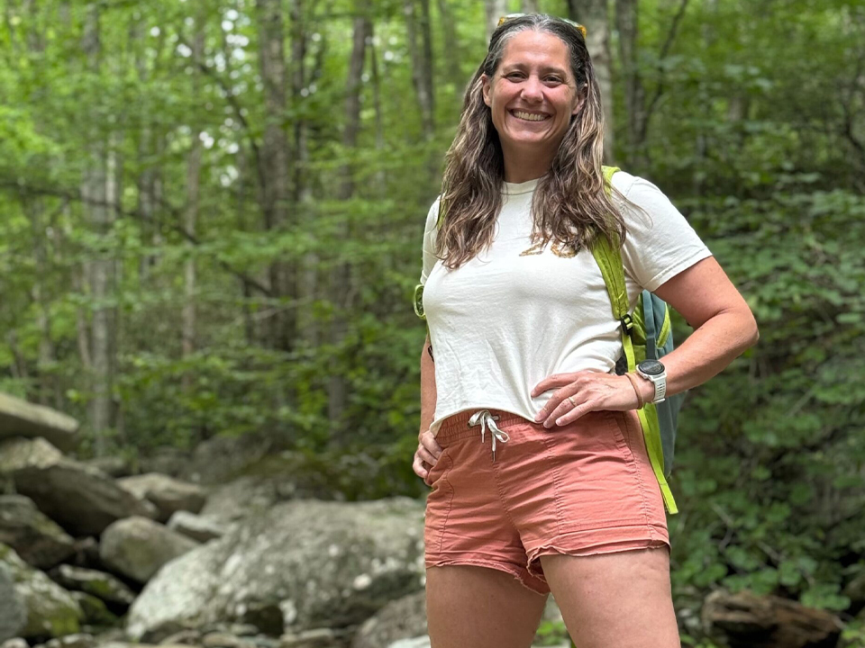 Picture of COO, Katie hiking on rocks.